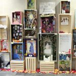 A variety of altars are stacked on one another for the exhibit