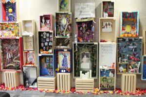 A variety of altars are stacked on one another for the exhibit