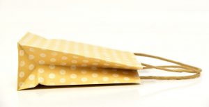 Yellow paper shopping bag lying on its side