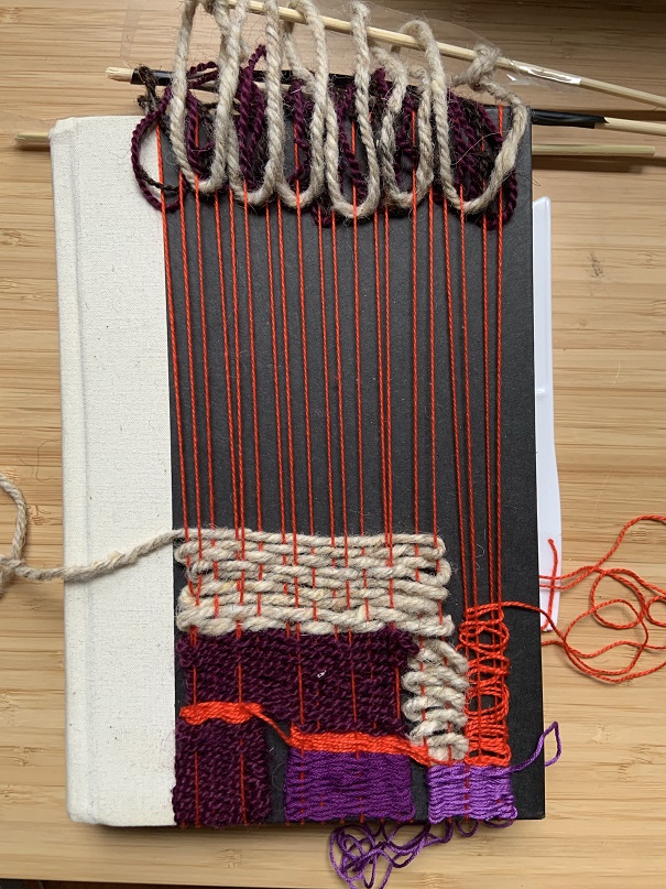 bright red, cream, and purple weaving over white book cover