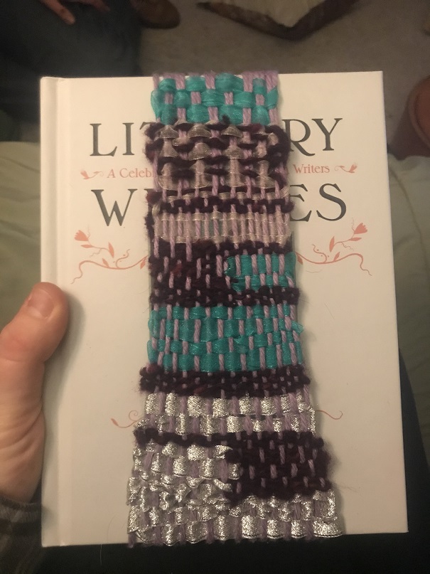 blue, purple, pink, silver weaving over white book cover