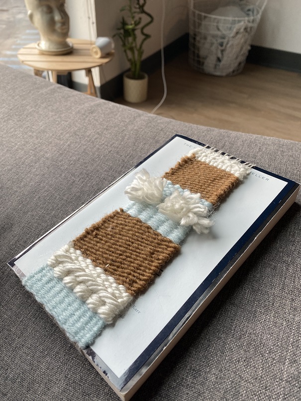 brown, cream, sky blue weaving over white book cover