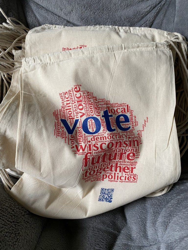 The students' collaborative design featured a Wisconsin-shaped word cloud printed locally on canvas bags. Photo by Grace Bauernfeind