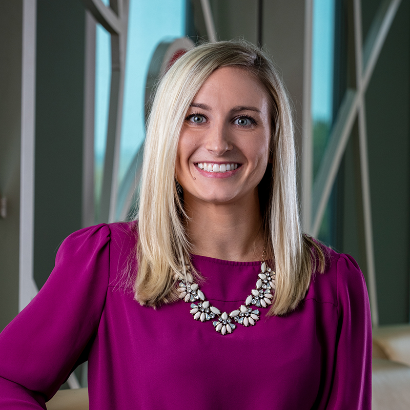 Professional photo of Lindsay Dritsas in front of the 100 Women Wall.