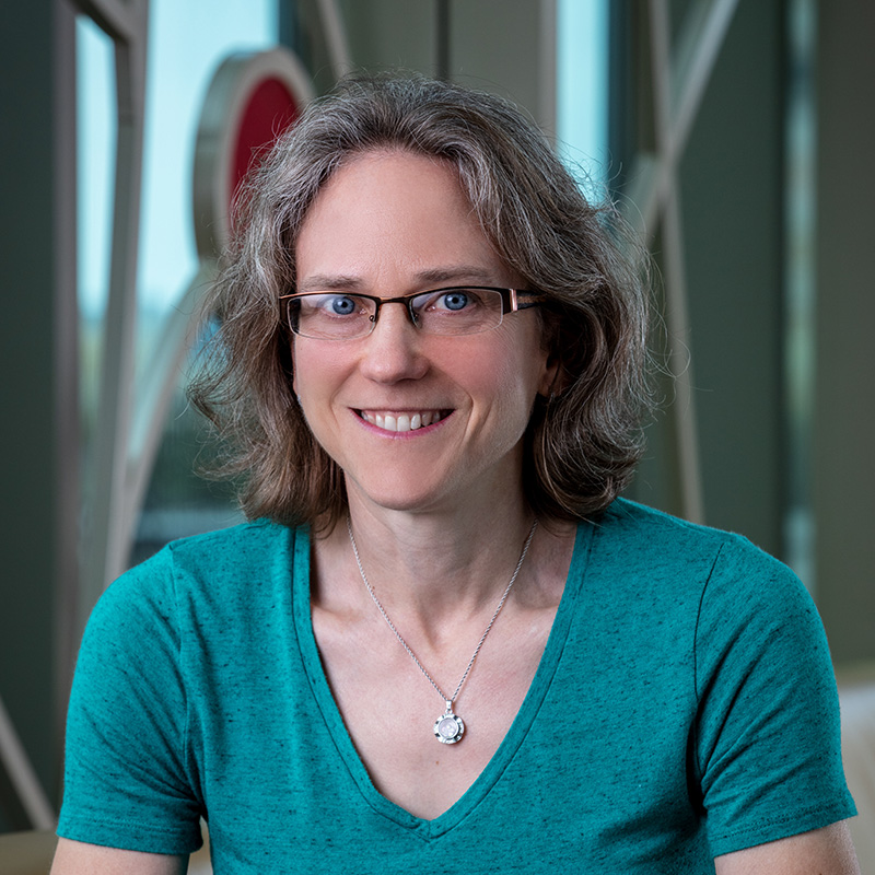 Professional photo of Sarah Marcotte in front of 100 Women Wall.
