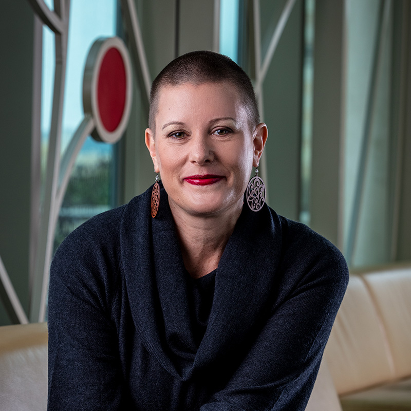 Professional photo of Susan Kitts in front of 100 Women Wall.