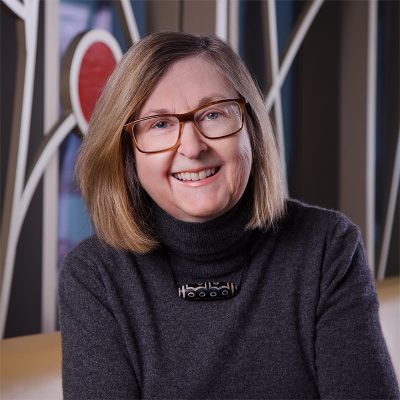 Professional photo of Terry Boyd in front of 100 Women Wall.