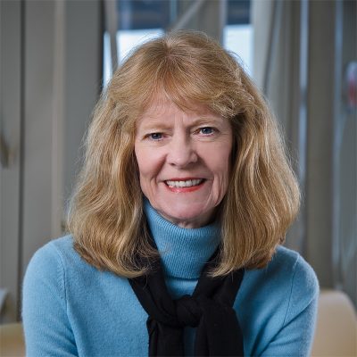 Professional photo of Wendy Way in front of 100 Women Wall.
