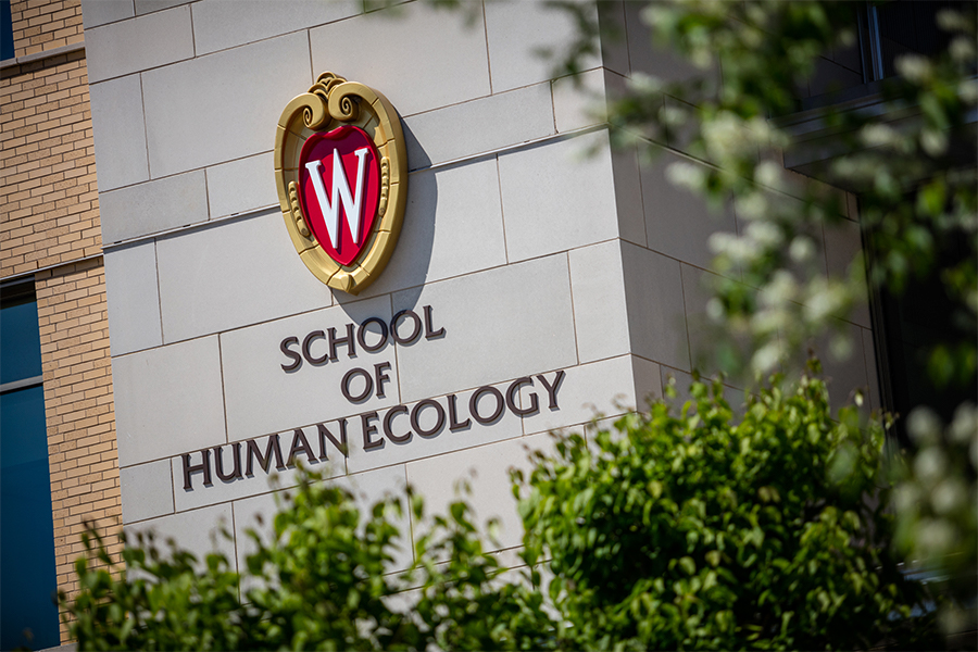 UW–Madison crest and School of Human Ecology sign on the outside of Nancy Nicholas Hall