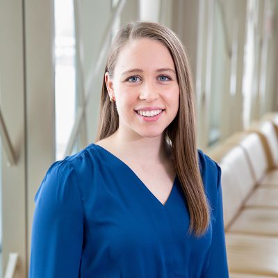 Professional photo of Kaitlyn Pritzl in front of 100 Women Wall.