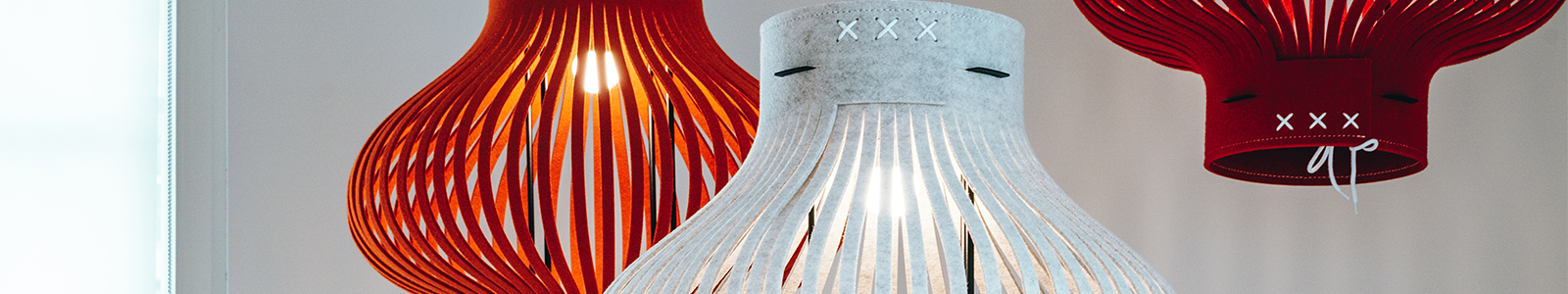 Closeup, cropped photo of red and white, felt lanterns in the Dorothy O'Brien Innovation Lab.