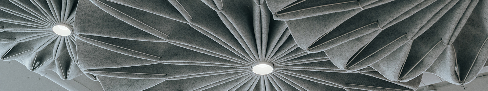 Closeup of three, gray, felt pinwheel lamps in the Dorothy O'Brien Innovation Lab.