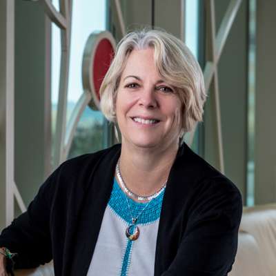 Professional photo of Carolyn Kallenborn in front of 100 Women Wall.