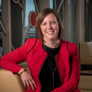 Claire Mezick smiling and wearing a red jacket