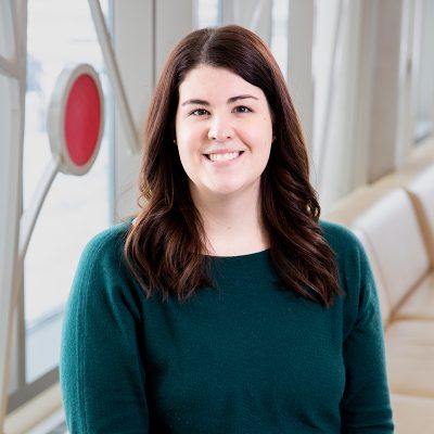 Professional photo of Michelle Hamilton in front of 100 Women Wall.