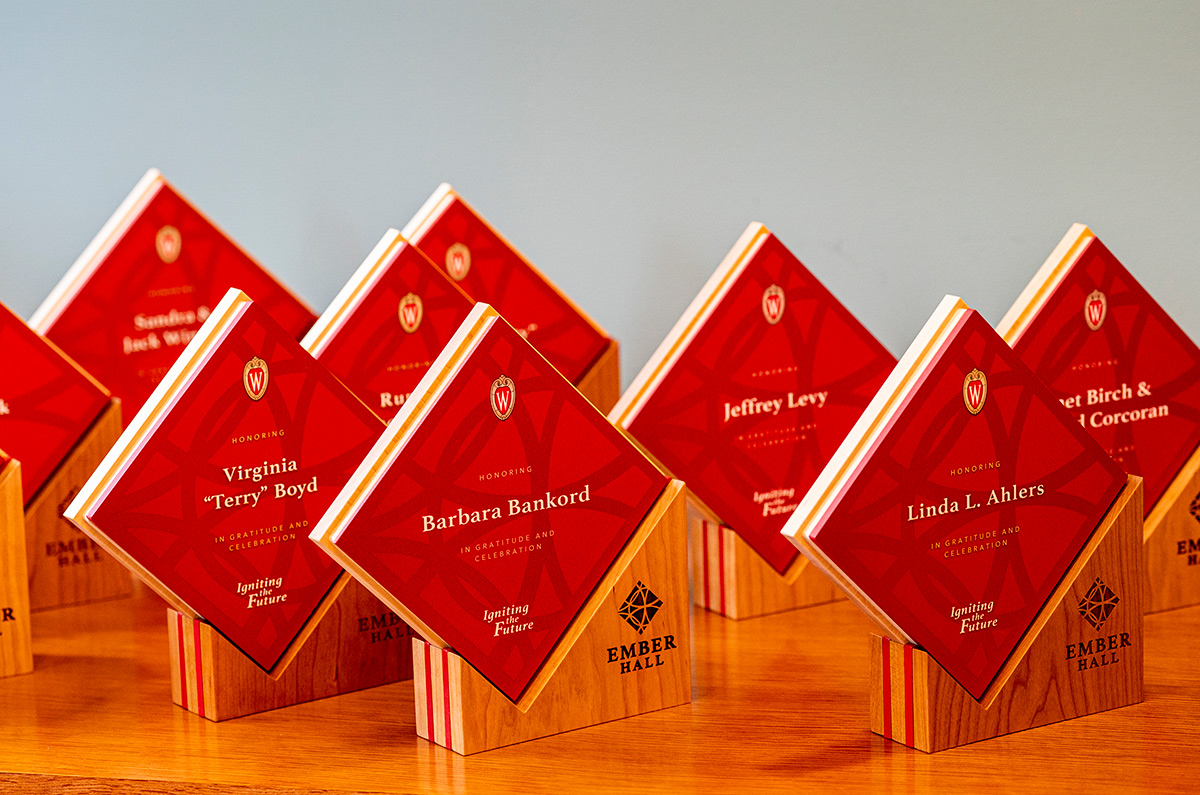 Several red, diamond plaques are lined up in three rows, on display
