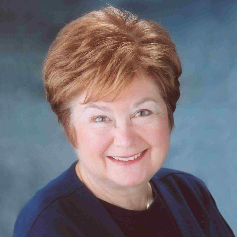 Professional portrait of Karen P. Goebel on a blue, textured background.
