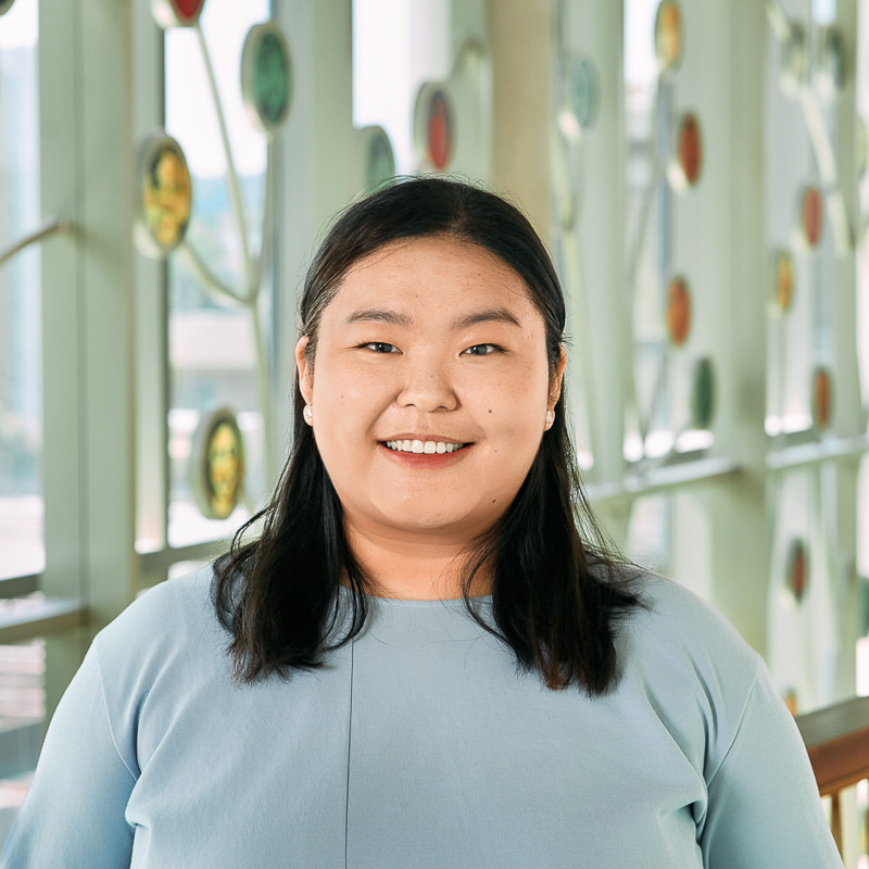 An east Asian women with black hair with a blue shirt.
