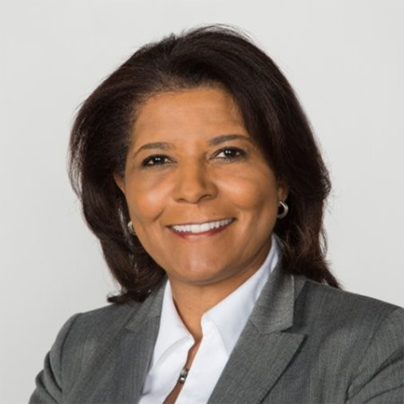 African American woman with white blouse and gray jacket