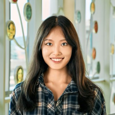 An Asian woman with long black hair, smiling at the camera.