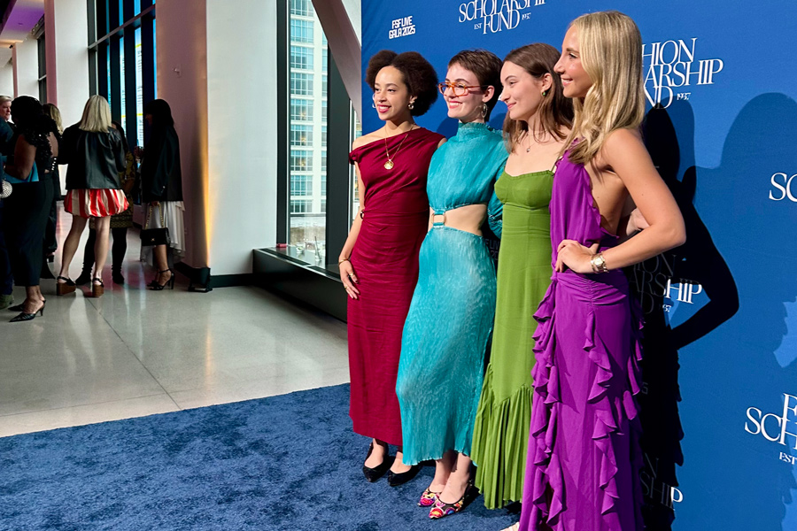 Four people in formal gowns stand and smile in front of a Fashion Scholarship Fund FSF Live Gala 2025 backdrop.
