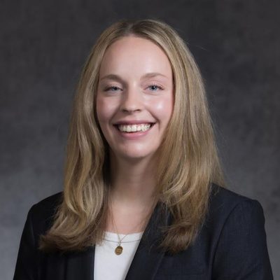 Professional photo of person with long blonde hair wearing a blazer.