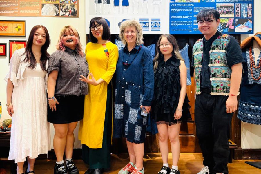 A group photo of six people standing side by side and smiling.