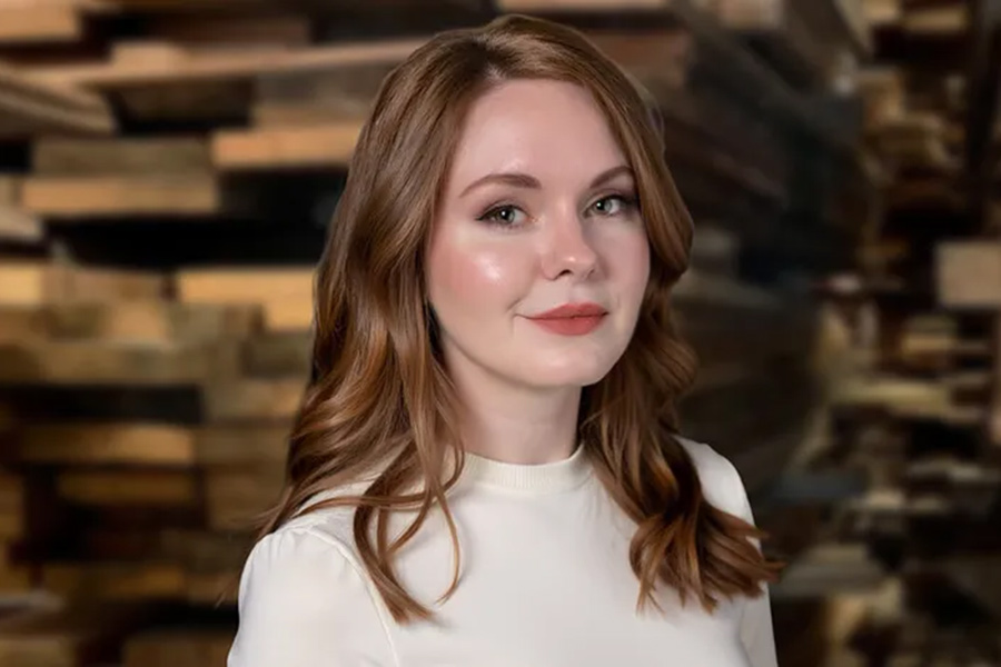 Professional headshot of Stephanie Phillips, a woman with reddish brown hair wearing a white mock-neck shirt.