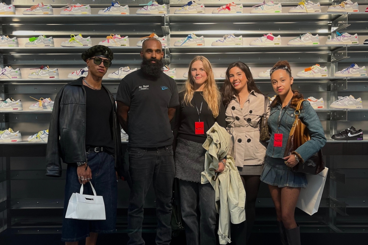 G standing with classmates in front of an exhibit display of shoes.